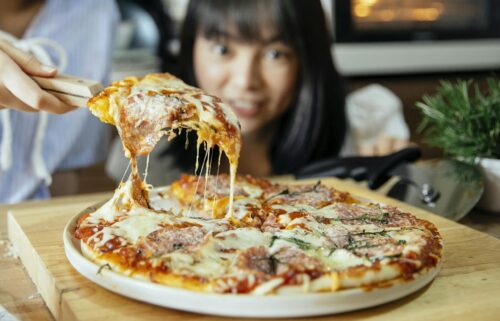 Delicious cheesy pizza with toppings being served hot and fresh from the oven.