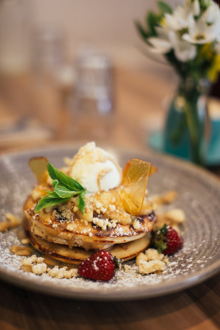 Indulge in a gourmet pancake dessert topped with fresh ingredients and served in a cozy setting.